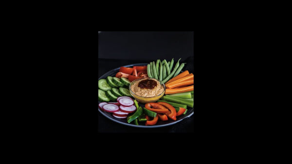 Creamy Phlippens Smoked Sauce Hummus platter with fresh vegetables.