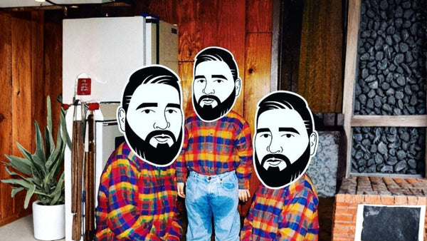 Three people wearing plaid shirts in a room with wooden walls and a plant.