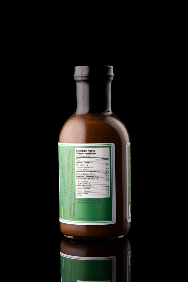 Back of Phlippen Jerk Sauce bottle, crafted in small batches with hand-smoked local ingredients, perfect as a versatile base for jerk chicken pizza or breakfast eggs.