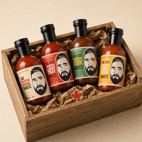Four sauce bottles in a wooden gift box with crumpled brown paper. The bottles have black caps and colourful labels featuring a stylized bearded man's face, with text showing the flavours.