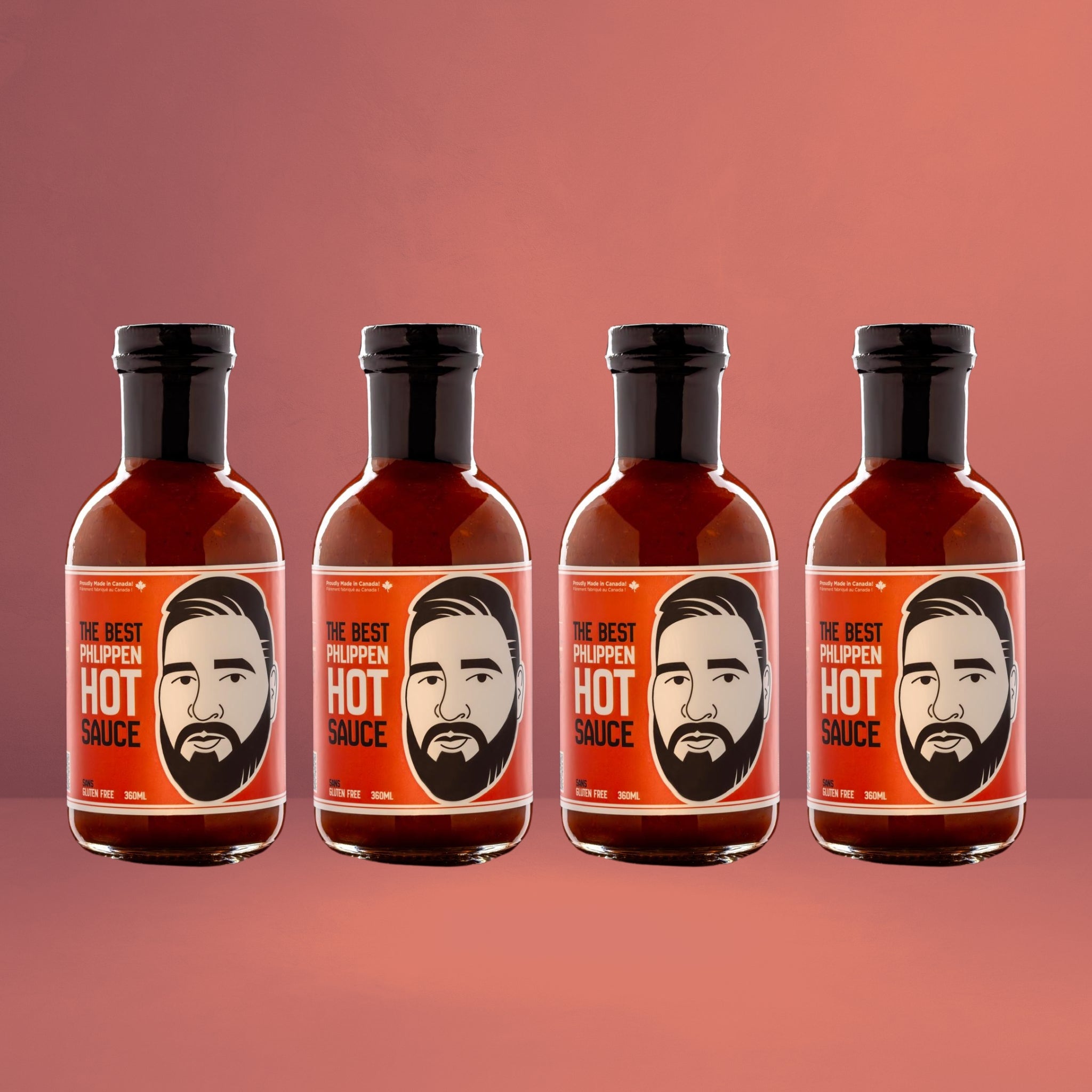 Four bottles of Phlippen's Hot Sauce in a line, showcasing the distinct labels with the iconic man's face graphic, set against a vibrant, bold red background.
